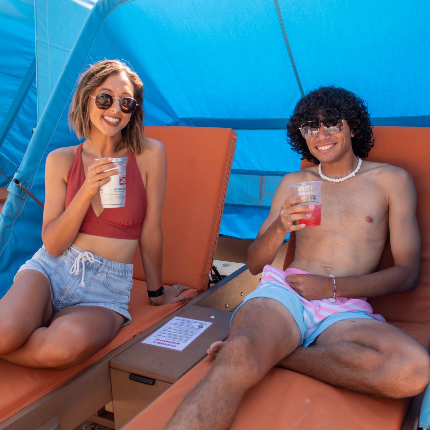 waterpark guests on loungers with drinks